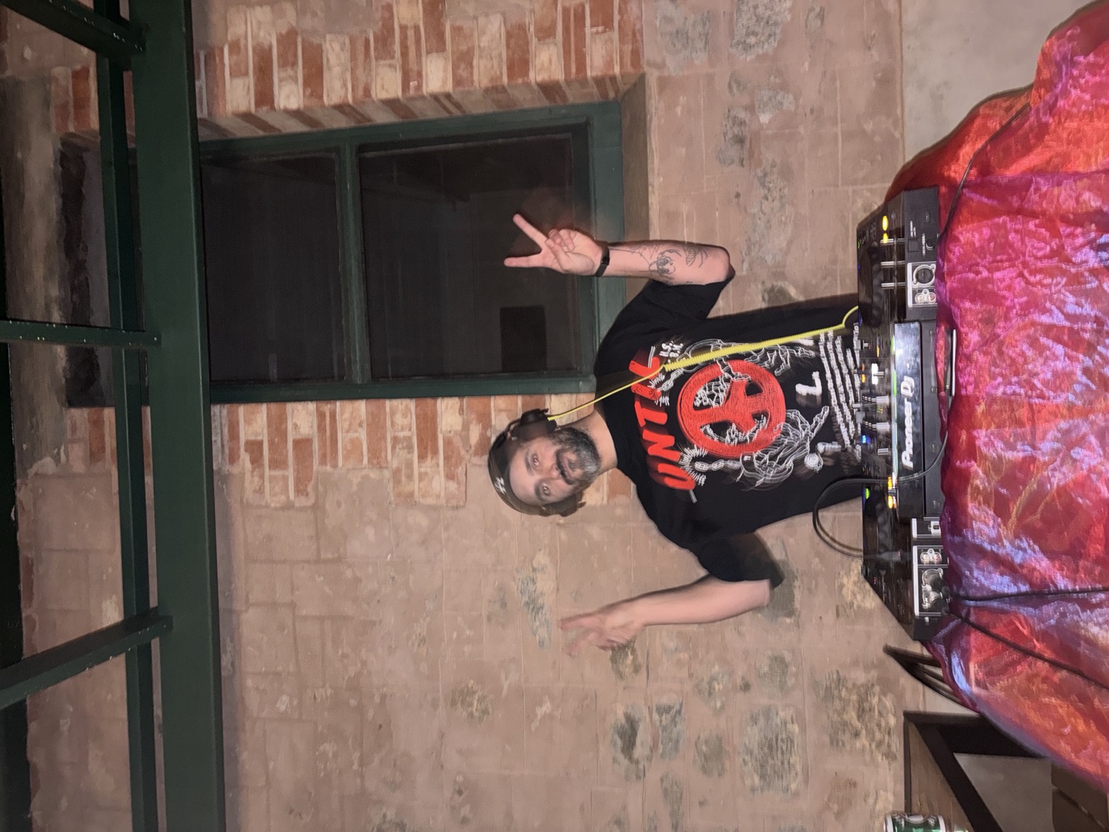 DJ throwing peace signs on the decks at Mary's Bar