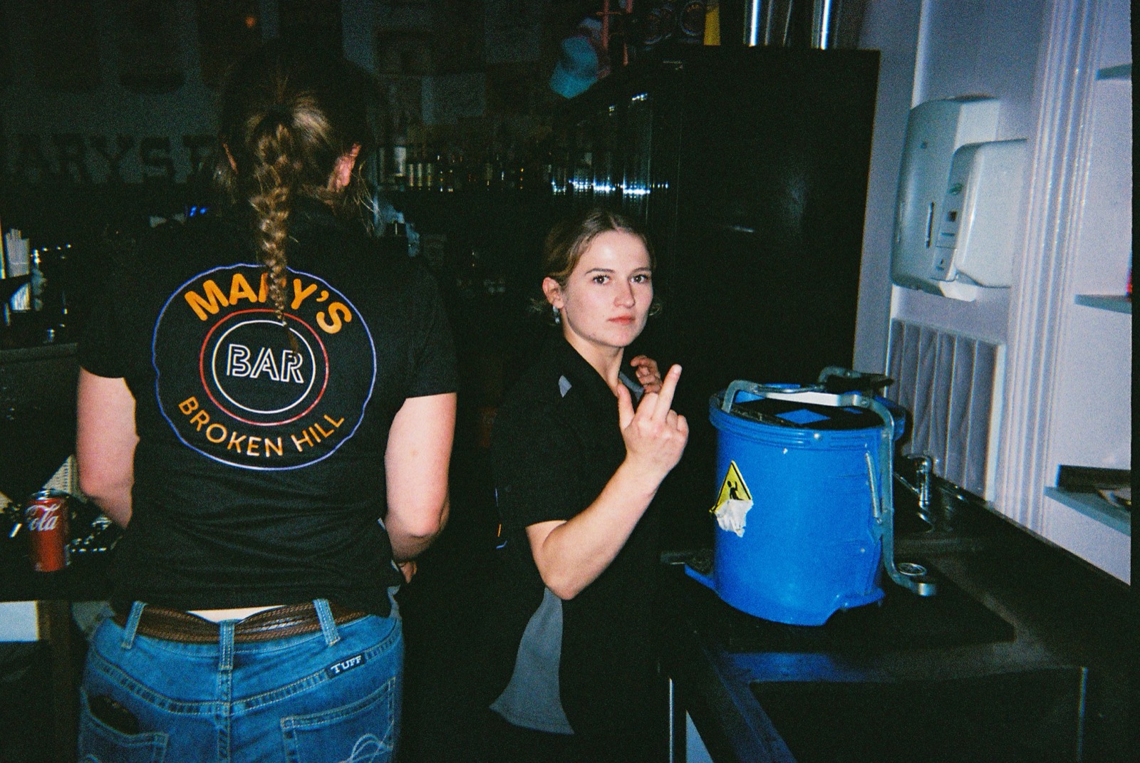Mary's Bar staff behind the bar in branded tees